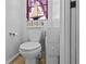 Small bathroom with a white toilet, small vanity and decorative accents at 4120 Tyndale Dr, Brandon, FL 33511