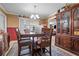 Traditional dining room with wooden furniture, carpet, and stylish chandelier at 4120 Tyndale Dr, Brandon, FL 33511