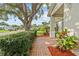 Charming front porch with a brick walkway, lush hedges, and colorful landscaping at 4120 Tyndale Dr, Brandon, FL 33511