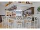Kitchen bar with granite countertops, seating for four, a wine rack, and views into the kitchen and living areas at 4120 Tyndale Dr, Brandon, FL 33511