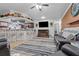 Inviting living room featuring a fireplace, TV, and adjacent kitchen bar at 4120 Tyndale Dr, Brandon, FL 33511