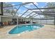 Backyard and in-ground pool with a screened enclosure and ample space for entertaining at 4120 Tyndale Dr, Brandon, FL 33511