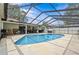 In-ground pool in screen enclosure with a view of the patio at 4120 Tyndale Dr, Brandon, FL 33511