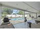Covered patio with an outdoor kitchen and furnishings, leading to a sparkling in-ground pool surrounded by a screened enclosure at 4120 Tyndale Dr, Brandon, FL 33511