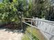 Backyard with gate leading to the backyard and a white fence at 4214 Foxboro Dr, New Port Richey, FL 34653