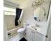 Bathroom features a bathtub with a shower, toilet, vanity, and mirror at 4214 Foxboro Dr, New Port Richey, FL 34653