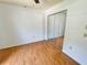 Bedroom with hardwood floors and closet with mirrored doors at 4214 Foxboro Dr, New Port Richey, FL 34653