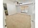 A spacious bedroom with carpet and a window provides natural light at 4214 Foxboro Dr, New Port Richey, FL 34653