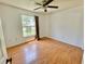 Bedroom with hardwood floors, ceiling fan, and natural light from window at 4214 Foxboro Dr, New Port Richey, FL 34653