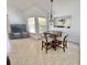 A quaint dining area features neutral tones, seating for four, and is illuminated by an elegant chandelier at 4214 Foxboro Dr, New Port Richey, FL 34653