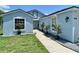 Lovely light blue single-Gathering home with a paved walkway and neatly trimmed landscaping and decorative rocks at 4214 Foxboro Dr, New Port Richey, FL 34653