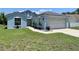 Charming light blue single-Gathering home with a well-maintained lawn and an attached two-car garage at 4214 Foxboro Dr, New Port Richey, FL 34653