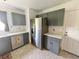A well-organized kitchen features stainless steel appliances, ample counter space, and sleek gray cabinets at 4214 Foxboro Dr, New Port Richey, FL 34653