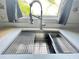 The kitchen features a modern stainless steel sink with a window view to the backyard at 4214 Foxboro Dr, New Port Richey, FL 34653
