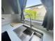 The kitchen features a modern stainless steel sink with a window view to the backyard at 4214 Foxboro Dr, New Port Richey, FL 34653