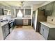 A bright kitchen is complete with stainless steel appliances, gray cabinets and sleek countertops at 4214 Foxboro Dr, New Port Richey, FL 34653