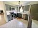 This kitchen showcases stainless steel appliances, tile backsplash, and gray cabinetry with plenty of storage at 4214 Foxboro Dr, New Port Richey, FL 34653