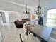 The living room features tile floors, vaulted ceiling, large window, and a chandelier that adds a touch of sophistication at 4214 Foxboro Dr, New Port Richey, FL 34653