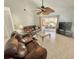 Well-lit living room featuring tile flooring, leather couches, and a sliding glass door to the screened-in patio at 4214 Foxboro Dr, New Port Richey, FL 34653