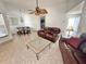 Inviting living room area with tile flooring, dining table with four chairs, and comfortable leather seating at 4214 Foxboro Dr, New Port Richey, FL 34653