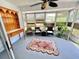 Bright sunroom with large windows, wicker furniture, and a ceiling fan, perfect for relaxation and enjoying natural light at 4214 Foxboro Dr, New Port Richey, FL 34653