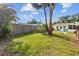 Green backyard with a wood fence and palm trees at 4226 4Th S Ave, St Petersburg, FL 33711