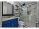 Bathroom featuring a modern vanity with a blue cabinet and a shower with glass doors at 4226 4Th S Ave, St Petersburg, FL 33711