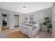 Serene bedroom featuring hardwood floors, white bedding, and a calming atmosphere at 4226 4Th S Ave, St Petersburg, FL 33711
