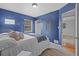 Another view of the stylish bedroom with navy walls, hardwood floors, and closet at 4226 4Th S Ave, St Petersburg, FL 33711