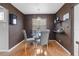 Dining room features brown walls, wood floor, glass table and gray chairs at 4226 4Th S Ave, St Petersburg, FL 33711