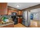 Kitchen with wood cabinets, stainless steel appliances, granite countertops and view to sunroom at 4226 4Th S Ave, St Petersburg, FL 33711