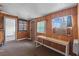 Small office space featuring wood paneled walls and carpet with a window A/C unit at 4226 4Th S Ave, St Petersburg, FL 33711