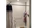 Clean, functional bathroom with a tiled shower, grab bar, and patterned shower curtain at 4433 Eternal Prince Dr, Sun City Center, FL 33573