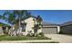Charming home with a well-maintained lawn, mature palm trees and a two car garage at 4433 Eternal Prince Dr, Sun City Center, FL 33573