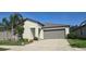 Well-maintained home featuring a two-car garage and manicured landscaping in a suburban neighborhood at 4433 Eternal Prince Dr, Sun City Center, FL 33573