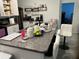 An open kitchen with a large countertop and ample storage, and modern white chairs at 4433 Eternal Prince Dr, Sun City Center, FL 33573