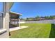 An expansive backyard showcases a screened-in patio and an eye-catching white fence at 445 Arch Ridge Loop, Seffner, FL 33584