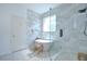 Bright bathroom featuring a modern tub, glass shower, and stylish tile at 445 Arch Ridge Loop, Seffner, FL 33584