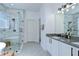 Spa-like bathroom with a glass-enclosed shower, modern vanity, and patterned tile flooring at 445 Arch Ridge Loop, Seffner, FL 33584