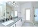 Clean bathroom with a gray counter, white cabinets and a large mirror at 445 Arch Ridge Loop, Seffner, FL 33584