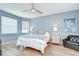 Calm bedroom with a ceiling fan, wood floors, and soft natural light from the window at 445 Arch Ridge Loop, Seffner, FL 33584