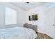 Bright bedroom featuring a dresser and TV at 445 Arch Ridge Loop, Seffner, FL 33584