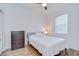 Simply furnished bedroom with a wood floor, ceiling fan, and a double bed at 445 Arch Ridge Loop, Seffner, FL 33584