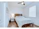 Bedroom featuring a fan, wood floor, and a queen bed at 445 Arch Ridge Loop, Seffner, FL 33584