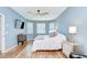 Serene bedroom featuring wood floors, a ceiling fan, and ample natural light at 445 Arch Ridge Loop, Seffner, FL 33584
