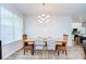 Dining room features a modern chandelier and hardwood floors at 445 Arch Ridge Loop, Seffner, FL 33584