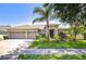 Charming home with a well-maintained lawn and a mature palm tree in the front yard at 445 Arch Ridge Loop, Seffner, FL 33584