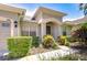 Close up of charming home's front entrance with colorful landscaping at 445 Arch Ridge Loop, Seffner, FL 33584