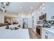 Stylish kitchen featuring white cabinetry, stainless steel appliances, and a mosaic tile backsplash at 445 Arch Ridge Loop, Seffner, FL 33584
