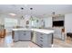 Modern kitchen island with gray cabinetry, stainless steel appliances, and open-concept layout at 445 Arch Ridge Loop, Seffner, FL 33584